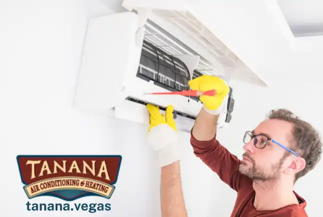 A professional AC technician servicing an air conditioning unit in a residential home in Las Vegas
